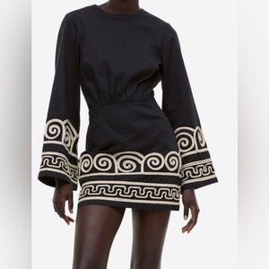 Black Mini Dress with Cream Scroll Embroidery.
Lyocell blend